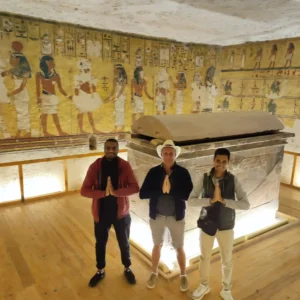due turisti conWael Rasmy il proprietario di egitto unico nella Valle delle Regine, davanti a un sarcofago decorato, durante la Gita Valle delle Regine, Deir el-Medina e Ramesseum da Luxor.